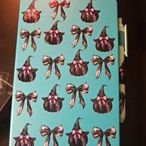 Pumpkins with witches hats and bows notebook and pen set.