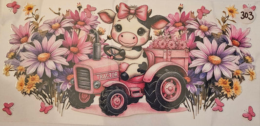 Highland cow riding a pink tractor