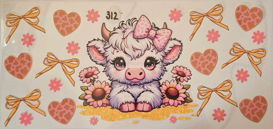 White highland cow with pink bow and yellow ribbons
